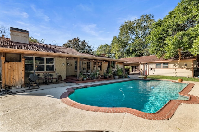 view of swimming pool with a patio