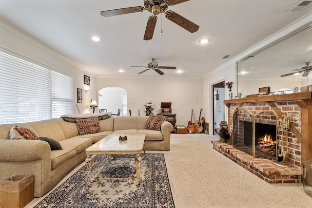 carpeted living room with a fireplace, ceiling fan, and ornamental molding