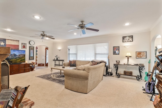 carpeted living room with ceiling fan and crown molding