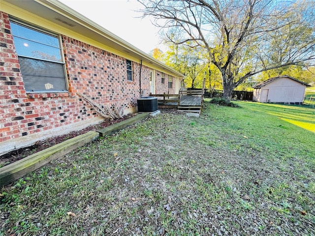 view of yard featuring a wooden deck and central AC