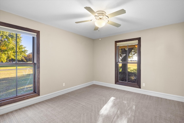 unfurnished room featuring baseboards, a ceiling fan, and carpet flooring