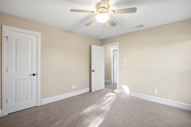 unfurnished bedroom with visible vents, ceiling fan, baseboards, and carpet