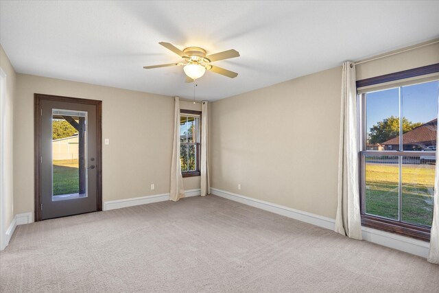 carpeted spare room with ceiling fan