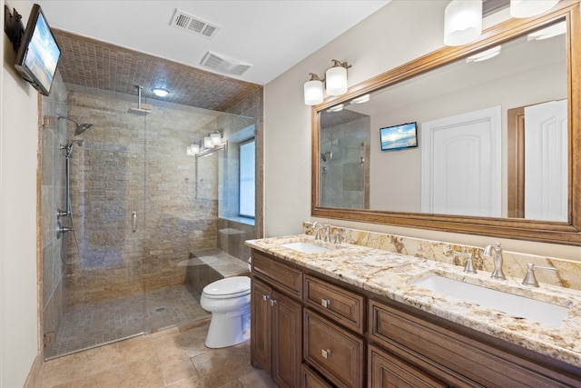 bathroom featuring tile patterned floors, toilet, an enclosed shower, and vanity