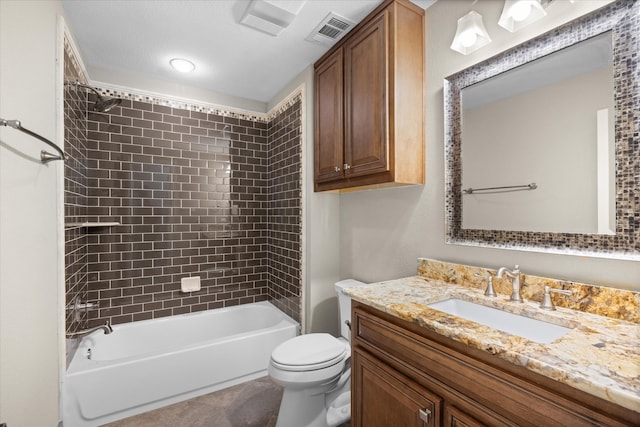 full bathroom with vanity, tiled shower / bath combo, and toilet