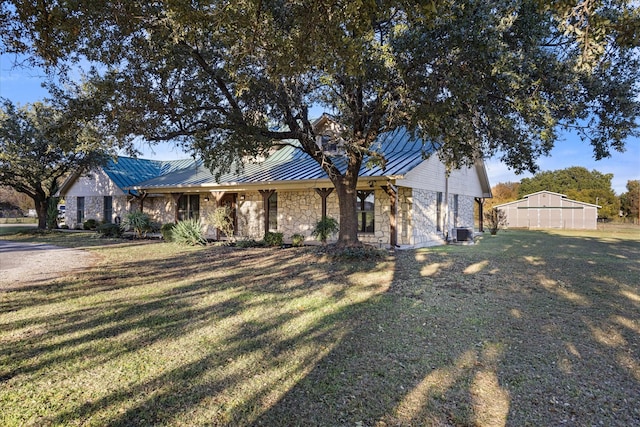 view of front of home with metal roof, stone siding, a front lawn, and a standing seam roof