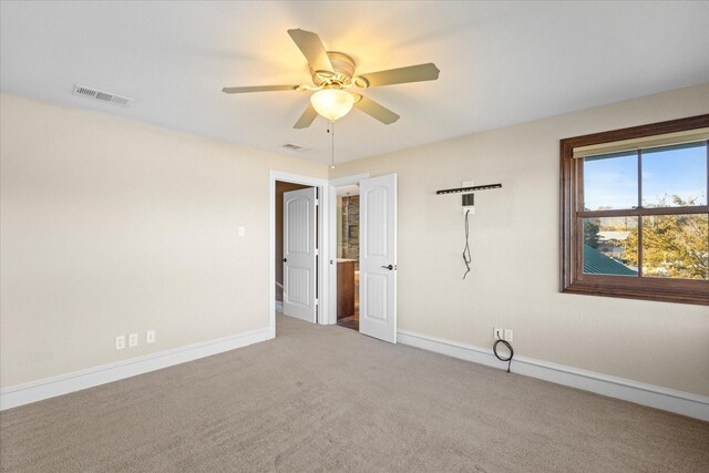 empty room featuring ceiling fan and carpet floors