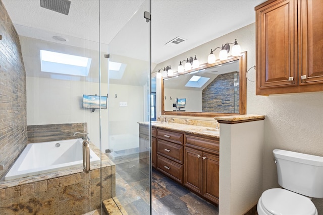 full bathroom featuring a skylight, separate shower and tub, a textured ceiling, toilet, and vanity