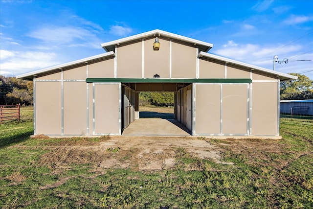 view of outbuilding with a carport, an outdoor structure, and an exterior structure