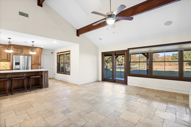 unfurnished living room featuring beamed ceiling, ceiling fan, and high vaulted ceiling