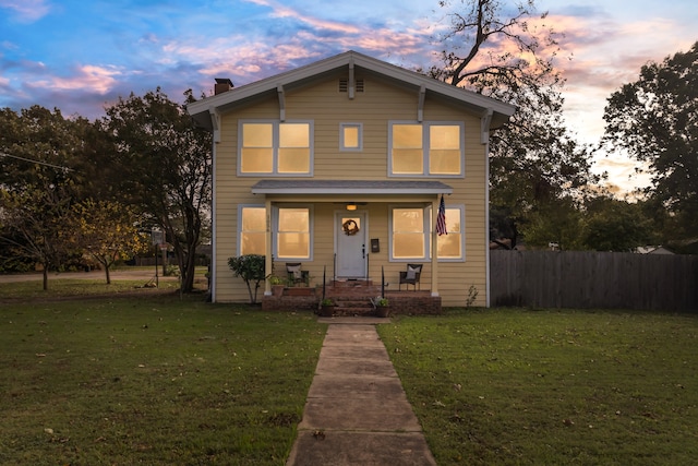 view of front facade featuring a porch and a lawn