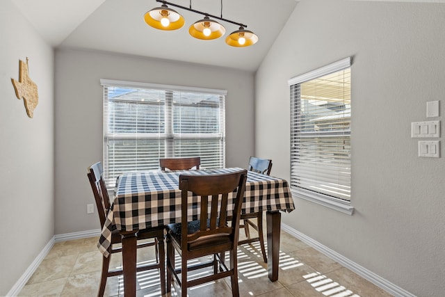 dining room with light tile patterned flooring and lofted ceiling