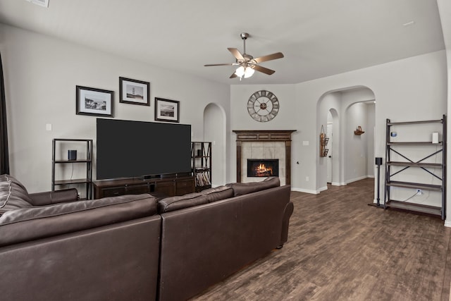 living room with ceiling fan, dark hardwood / wood-style flooring, and a fireplace