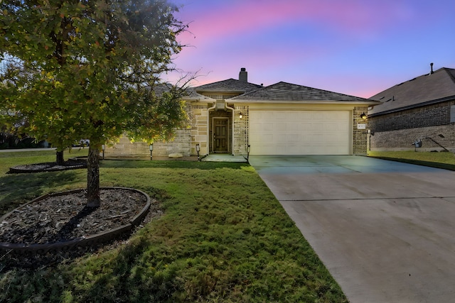 view of front facade with a lawn and a garage