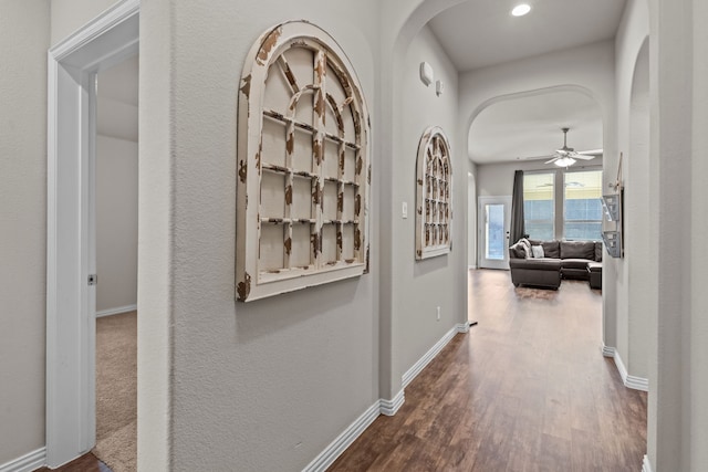 hallway with hardwood / wood-style flooring