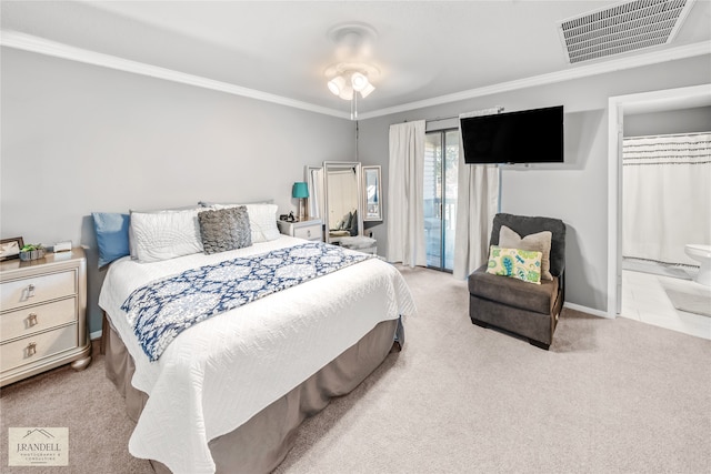 carpeted bedroom with ensuite bath, ceiling fan, and crown molding