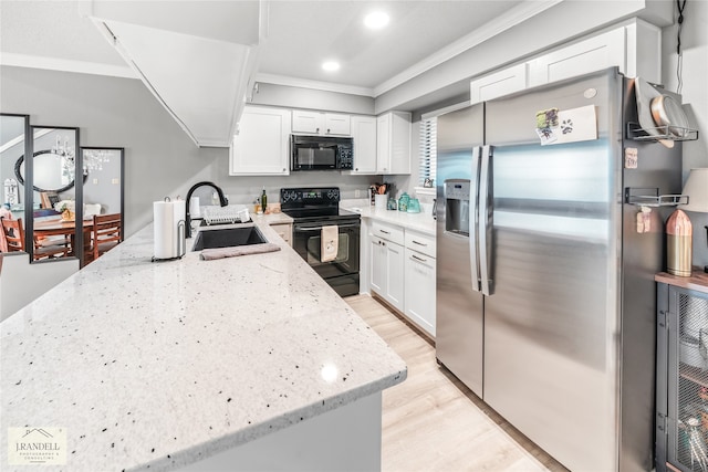 kitchen featuring sink, white cabinets, black appliances, and light wood-type flooring