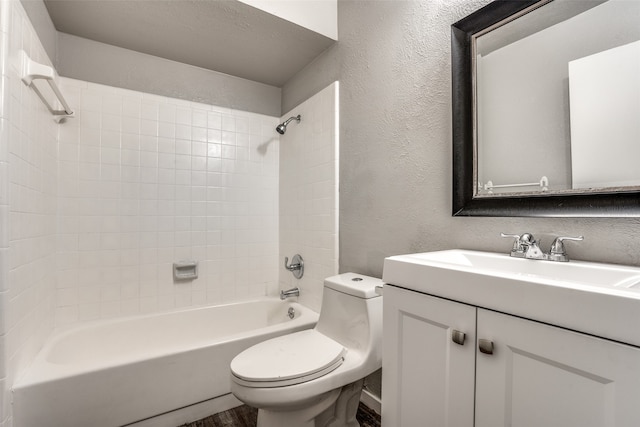 full bathroom featuring vanity, toilet, and tiled shower / bath