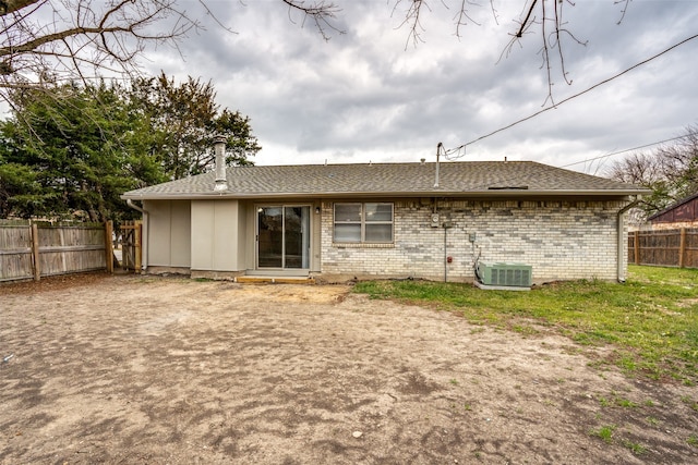 rear view of property with central AC