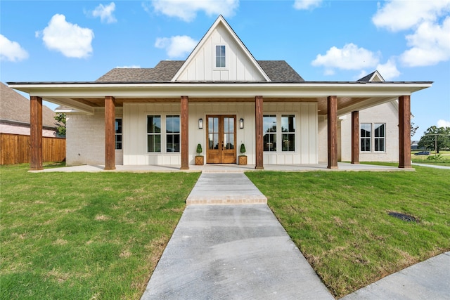 view of front facade featuring french doors and a front lawn