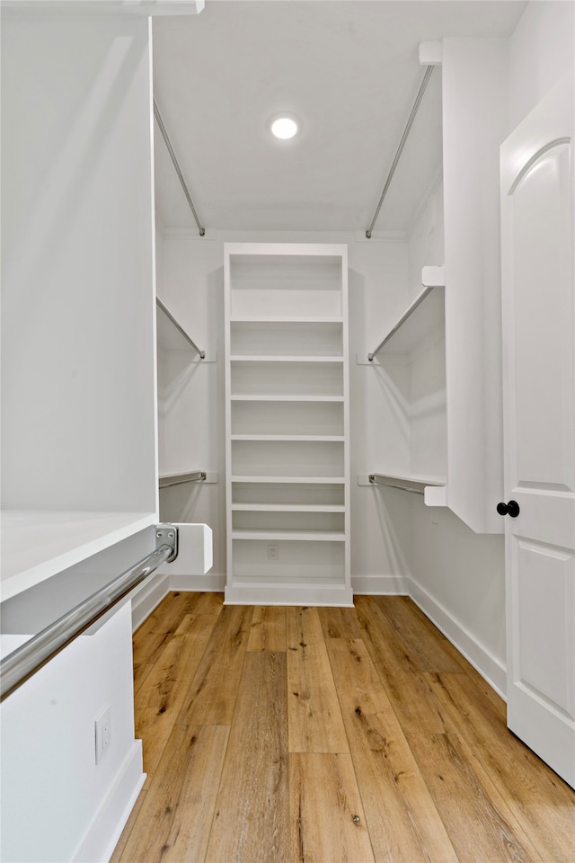 spacious closet with hardwood / wood-style flooring