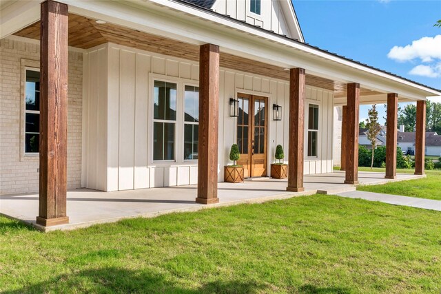 exterior space with covered porch and a yard