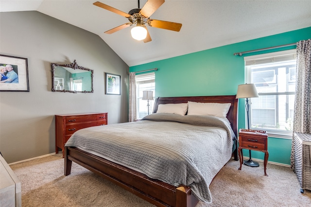 bedroom featuring ceiling fan, light colored carpet, and vaulted ceiling