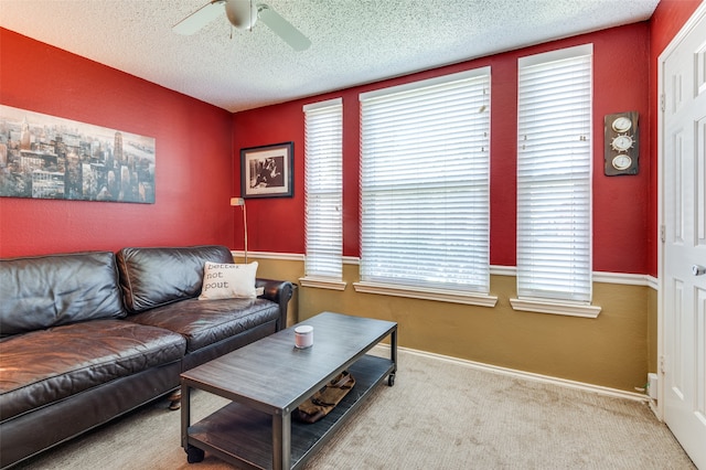 carpeted living room with ceiling fan and a textured ceiling