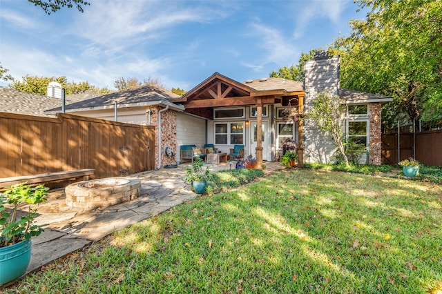 rear view of property with a patio area and a yard