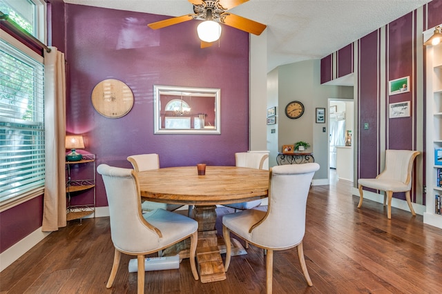 dining space featuring a textured ceiling, ceiling fan, and dark wood-type flooring