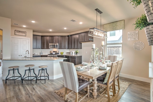 dining area featuring dark hardwood / wood-style flooring and sink