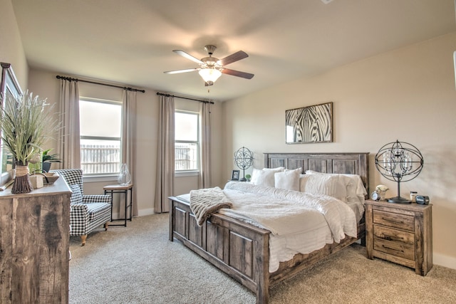 bedroom with ceiling fan and light colored carpet