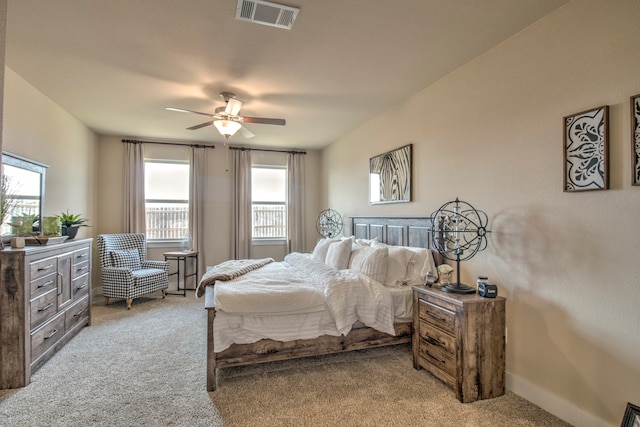 bedroom featuring ceiling fan and light carpet