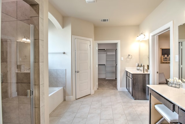 bathroom featuring vanity, tile patterned flooring, and plus walk in shower