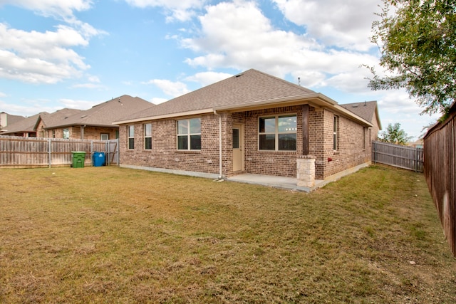 rear view of house featuring a lawn