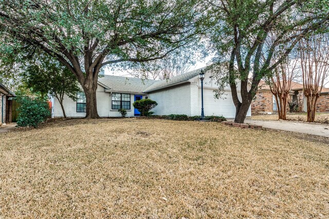 exterior space featuring a garage and a front yard