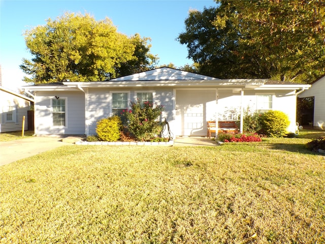 view of front of house featuring a garage and a front lawn