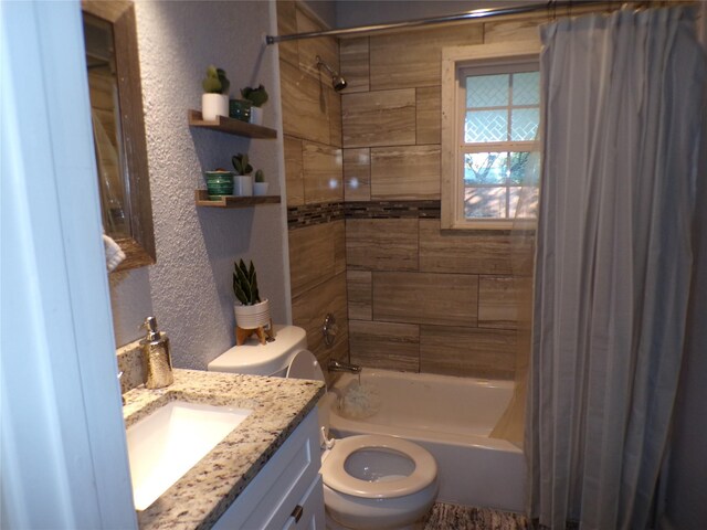 full bathroom with shower / bath combo with shower curtain, vanity, and toilet