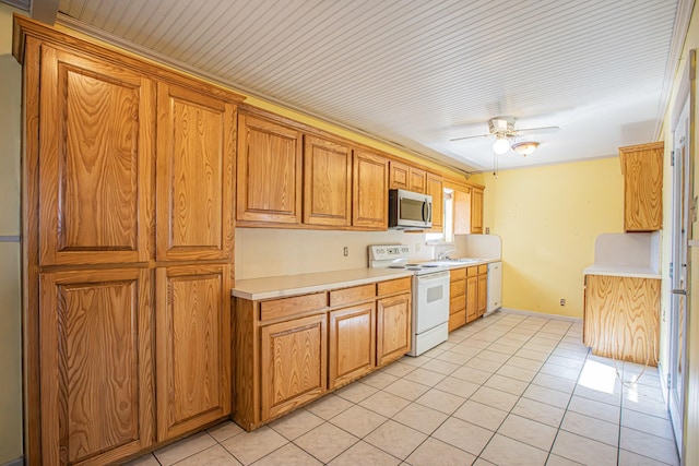 kitchen with ceiling fan, light tile patterned floors, sink, and white appliances