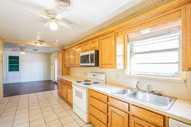 kitchen with ceiling fan, sink, white appliances, and light tile patterned flooring