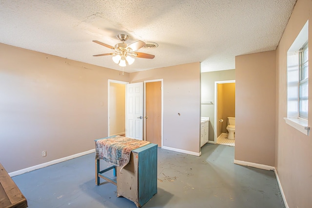 office featuring ceiling fan and a textured ceiling