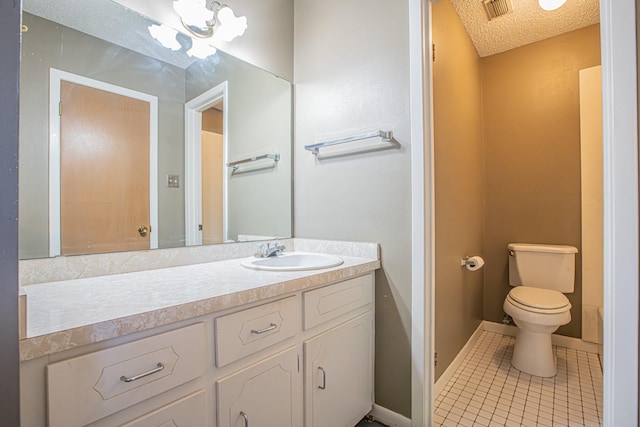 bathroom featuring a textured ceiling, tile patterned floors, vanity, and toilet