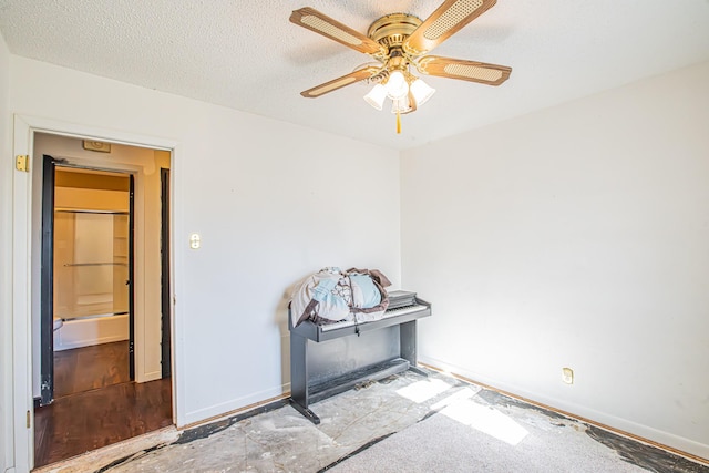 interior space with ceiling fan and a textured ceiling