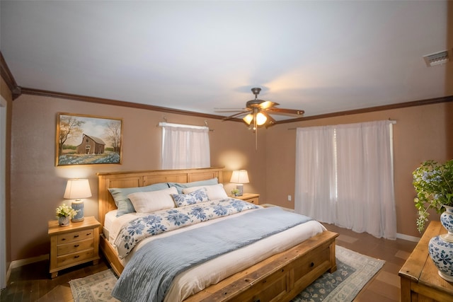 bedroom featuring dark hardwood / wood-style flooring, ceiling fan, and ornamental molding