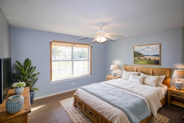 bedroom with dark tile patterned flooring and ceiling fan