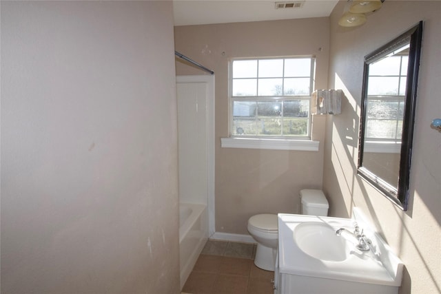332 NW County Road 2005, Corsicana, TX 75110 - bathroom with toilet, tile patterned floors, vanity, baseboards, and washtub / shower combination