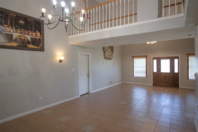 interior space featuring tile patterned floors, a high ceiling, and a notable chandelier