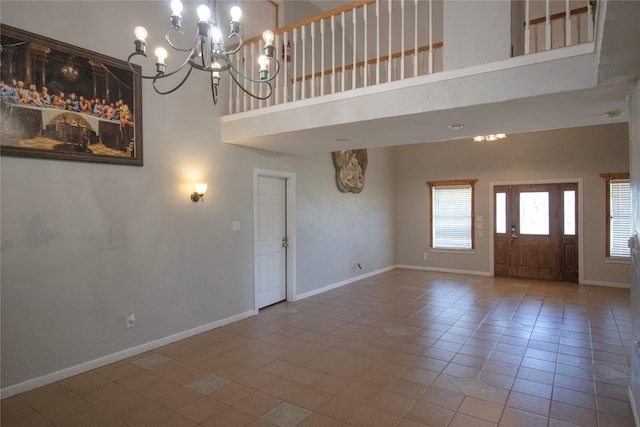 332 NW County Road 2005, Corsicana, TX 75110 - unfurnished living room featuring a high ceiling, a chandelier, tile patterned floors, and baseboards
