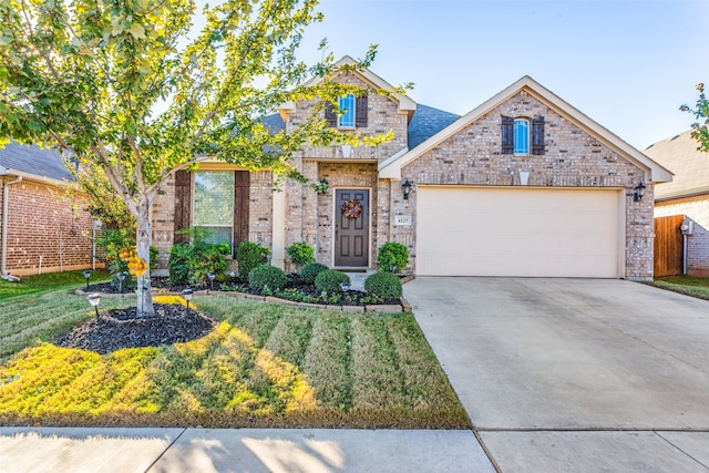 view of front of home featuring a garage and a front lawn