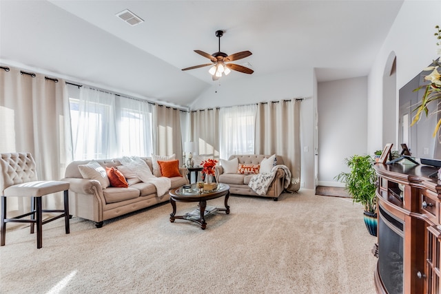 carpeted living room with ceiling fan and lofted ceiling